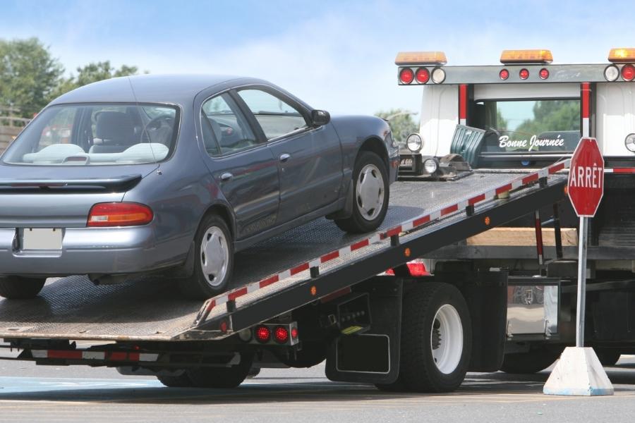 vehicle being transported by towing truck at street gonzalez tx